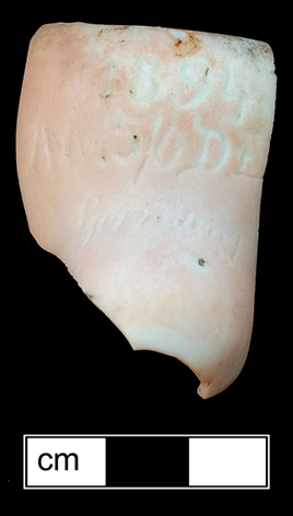 The back part of the neck of a bisque socket head porcelain doll produced in Germany. The mark &ldquo;1894 AM 5/0 DE&rdquo; indicates a doll made by the manufacturer Armand Marseille - from 18MO609.